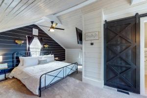 a bedroom with a bed and a barn door at The Towpath Retreat-A Cozy Farmhouse Stay in Canal Fulton