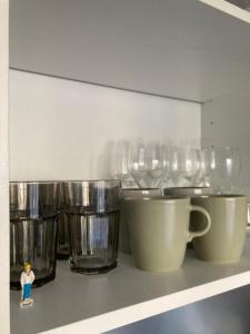 a row of silver cups sitting on a shelf at Nice west cosy flat balcony, near airport, train, beach, public transport, supermarket, comfortable and well equipped in Nice