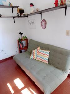 a couch with a pillow on it in a room at Departamento con terraza in Corrientes