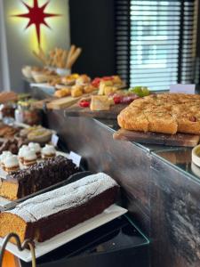 a buffet of different types of bread and pastries at La Olivia Hotel Boutique & Spa in La Falda