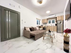 a living room with a couch and a table at Corfu Airport Sweet Home in Agios Rokkos