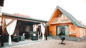 a house with a deck with a hot tub at Cabana Ioana Cacica in Cacica