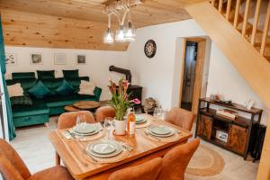 a living room with a wooden table and chairs at Cabana Ioana Cacica in Cacica