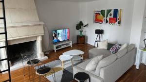 a living room with a couch and a tv at VUE SUR LA SEINE in Paris