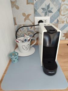 a computer printer and a cup on a counter at vinaka in SantʼAlessio Siculo +15 photos