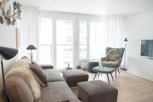 a living room with a couch and a chair at Stylish apartment with mountain view in Lenzerheide