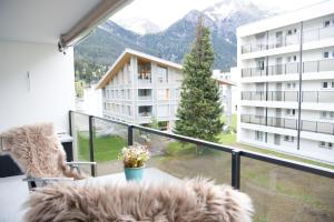 a balcony with a view of a building at Stylish apartment with mountain view in Lenzerheide