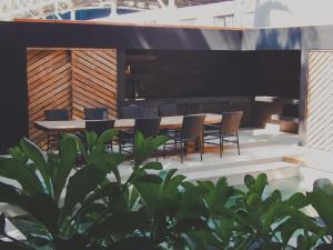 a large piano on a patio with a table and chairs at Casa Matt & Marshall in Brisas de Zicatela +4 photos