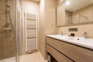 a bathroom with a sink and a shower at Casa Matti - Modern Apartment with Canal View and Terrace in Ghent +14 photos