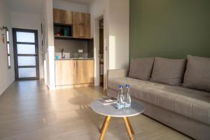 a living room with a couch and a table at Kiteriders Garden Villas in Ulcinj +17 photos
