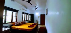 a bedroom with a bed in a room with windows at David Homes in Cochin
