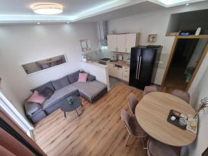 a living room with a couch and a table at Apartman Lucia in Mimice