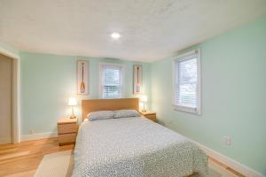 a bedroom with a bed and two lamps in it at Serene South Haven Retreat with Deck 1 Mi to Dtwn! in South Haven