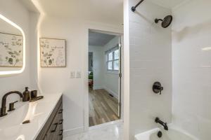 a white bathroom with a tub and a sink at Serene South Haven Retreat with Deck 1 Mi to Dtwn! in South Haven +25 photos