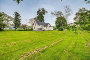 a large field with a house in the background at Serene South Haven Retreat with Deck 1 Mi to Dtwn! in South Haven