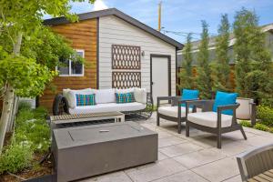 a patio with a couch and chairs and a grill at Highlands Square Bungalow - Private Yard - Garage in Denver