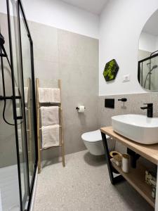 a bathroom with a sink and a toilet at New Premium Apartment Rivetta in Poreč
