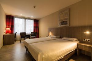 Postel nebo postele na pokoji v ubytování De Keyser Hotel