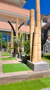 a row of bamboo columns in front of a building at Bellavista luxury apartments in La Caletta +48 photos