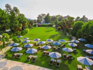 an overhead view of a park with blue and white umbrellas at Hotel Club-E in Fethiye