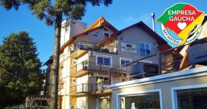 a building with a sign in front of it at Sky Centro Hotel & SPA in Gramado