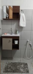 a bathroom with a sink and a shower at Sítio Recanto Amado. in Santa Teresa