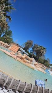 a water park with chairs and a water slide at Mobil home les sables d'or in Cap d'Agde