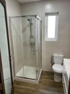 a bathroom with a shower and a toilet at Sea side view 2 bedroom apartment with terrace Beppe`s apartment in St Paul's Bay +13 photos