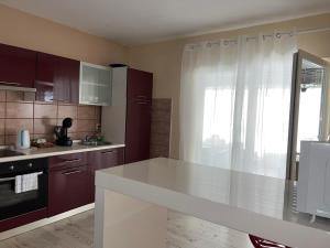 a kitchen with a white counter top and a window at kuća za odmor Domus Alba in Branjin Vrh