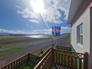 a balcony with a flag on the side of a building at Helgafell Guesthouse in Stykkishólmur