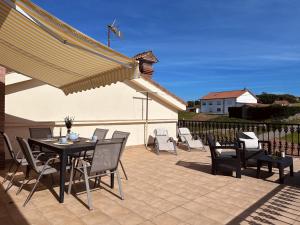 a patio with a table and chairs and an umbrella at El Trocador - 12805 in Ajo