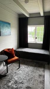 a bedroom with a bed and a window at Ladegaarden in Skien