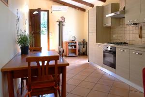a kitchen with a table and chairs in a room at Appartamento in villa al mare in Siracusa