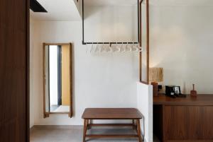 a room with a wooden table and a stool at Boho Sapiens Sea View in Adamas