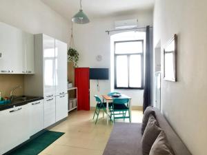 a kitchen and dining room with a table and chairs at castle apartment in Bari