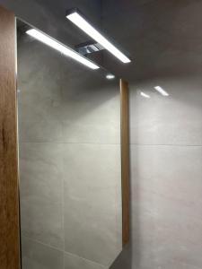a room with a sliding glass door with a light at Apartment G17 in Pernik +19 photos