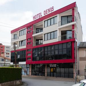 a building with a hotel cleaners sign on it at Denis Hotel in Prizren