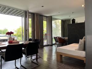 a living room with a bed and a table and chairs at Holidayhome Elza in Innsbruck