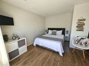a bedroom with a bed and a television in it at Fascinante Orbita Apartments in Vila Nova de Famalicão