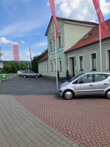 a silver car parked in front of a building at Chausseehaus - Ferienwohnungen Rottleberode am Harzrand in Rottleberode +2 photos