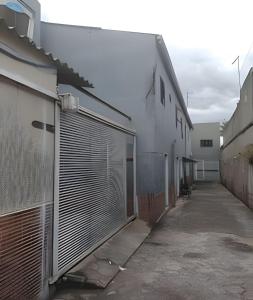 a white building with a gate and a garage at Apto n.09 condominio custo beneficio. in Brasília +5 photos