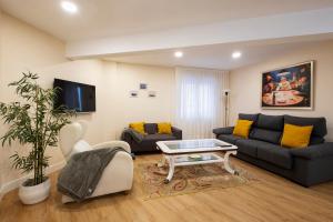 a living room with a couch and a table at Astillerogane in Bermeo