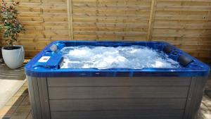 a hot tub with water in it on a patio at Holiday House Zrmanja Vrelo in Krupa