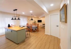 a kitchen and living room with a table and chairs at Astillerogane in Bermeo