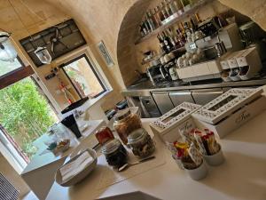 a kitchen with a counter with some food on it at Maison d'Ax in Matera