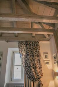 a curtain in a room with a window at Barbacan Boutique Hotel in Trieste