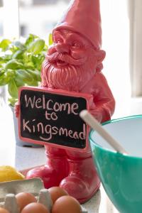 a statue of a santa holding a welcome to kingserved sign at Dream Stays Bath - Kingsmead Street in Bath