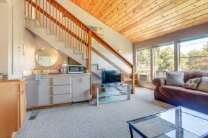 a living room with a couch and a staircase at Auburn Cottage with Patios and Garden - 3 Mi to Town! in Auburn