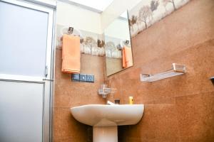 a bathroom with a sink and a mirror at Ocean Grace in Arugam Bay