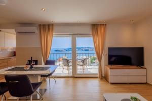 a kitchen and living room with a view of the ocean at Apartment Maya in Podstrana